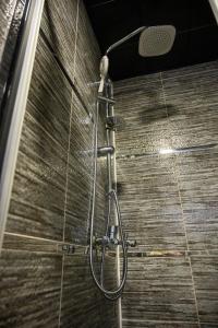 a shower with a shower head in a bathroom at DS REGULUS in Ankara
