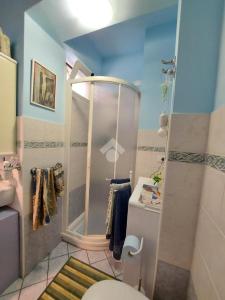 a small bathroom with a toilet and a shower at Monolocale IL GRIFO in Albisola Superiore