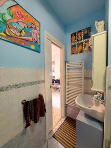 a bathroom with a sink and a toilet and a mirror at Monolocale IL GRIFO in Albisola Superiore