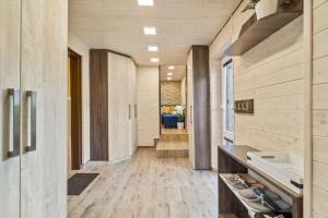 a hallway with wood paneled walls and a hallway with shoes at Chata Řeka in Řeka