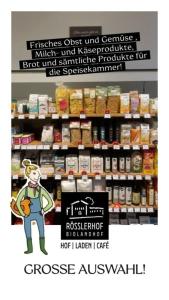 a store with a sign in front of a shelf of food at Rösslerhof Ferienwohnung Obstwiese 