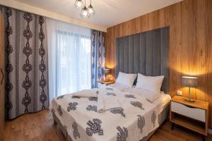 Posteľ alebo postele v izbe v ubytovaní Resorts G Białka Tatrzańska z sauną, Sun & Snow