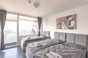 2 Betten in einem Schlafzimmer mit Fenster in der Unterkunft TOP 60qm Eigentumswohnung Neuss/DüsseldorfMesseKÖ in Neuss