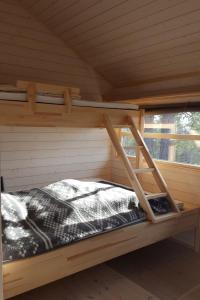 a wooden bunk bed in a cabin with a window at Myrullen - Cabin at Sørbølfjellet in Flå