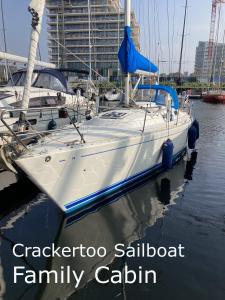 a boat docked in a marina with words crazykota sailboat family at Entire Boat at St Katherine Docks 2 Available select using room options in London