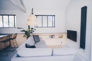 a living room with a white couch and a table at Blackett Street Bunkhouse - Calverley in Leeds