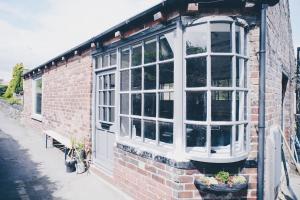 a brick building with a window and a bench at Blackett Street Bunkhouse in Leeds