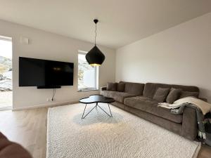 a living room with a couch and a table at Nice villa for 10 people on Styrso in Styrsö