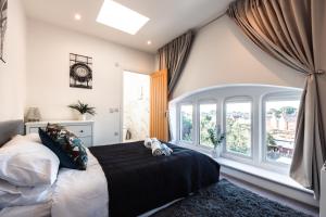 a bedroom with a bed and a large window at King's House by Smart Apartments in Southampton