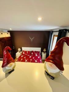 a bedroom with a bed and two gnomes sitting on a table at Neve monolocale, ottima posizione, posto auto. in Bormio