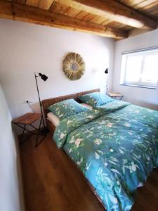 een slaapkamer met een bed met een blauw dekbed bij Rösslerhof Ferienwohnung Stiller Bach 