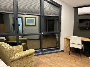 a living room with a large window and a chair at Taşliman Otel in Yalova