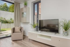 a living room with a large television and a chair at Michels Kate in Heiligenhafen