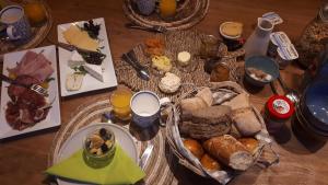 a table topped with lots of different types of bread at at Number 1 in Rumst
