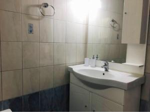 a bathroom with a sink and a mirror at ΗΒΗ MINI HOME in Chalkida