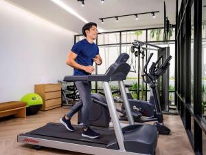 a man on a treadmill in a gym at Hotel Ibis Samui Bophut in Bophut