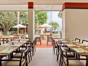 a row of tables and chairs in a restaurant at Hotel Ibis Samui Bophut in Bophut