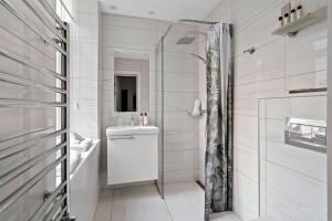 a bathroom with a shower with a toilet and a sink at Best Western Hotel Hebron in Copenhagen