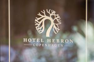 a sign on a window of a hotel hebrewederation at Best Western Hotel Hebron in Copenhagen