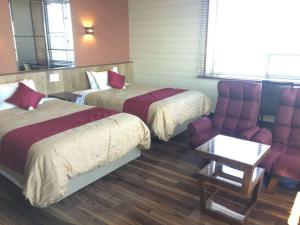 Ein Bett oder Betten in einem Zimmer der Unterkunft LiVEMAX RESORT Sakurajima Sea Front
