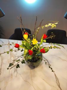 a glass vase filled with flowers on a table at Nino Luxury Apartment in Zagreb