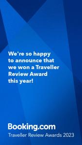 a blue sign that says were so happy to announce that we won a traveler at petros house in Sarti