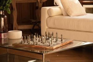 a chess set on a table in front of a couch at La Villa Barbieux in Roubaix +28 photos