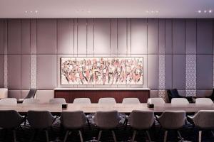 uma sala de conferências com cadeiras e um quadro na parede em Grand Hyatt Kuwait em Kuwait