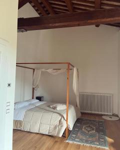 a bedroom with a canopy bed and a rug at Abbazia Sette Frati Agriturismo Fratres in Pietrafitta