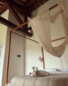 a bedroom with a bed with a mosquito net at Abbazia Sette Frati Agriturismo Fratres in Pietrafitta