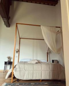 a bed with a canopy in a bedroom at Abbazia Sette Frati Agriturismo Fratres in Pietrafitta