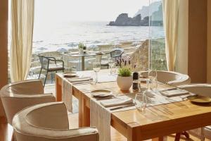 a dining room with a table and a view of the ocean at Pelekas Monastery in Pelekas