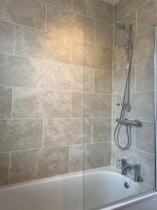 a bathroom with a shower and a bath tub at Lovely little house in Yarrowford - Yarrow Valley in Broadmeadows