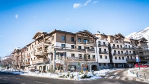 a large building on a street in the snow at Appartement Relax in Bourg-Saint-Maurice
