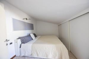 Dormitorio blanco con cama y pared en Casa Giulia, en Florencia