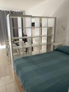 a bedroom with a large bed with glass shelves at Tobago508 in Puerto Rico de Gran Canaria