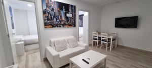a living room with a white couch and a table at APTO TANEZ NEW YORK STYLE, a in Madrid