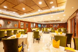 um restaurante com mesas e cadeiras num quarto em Fortune Park Pushpanjali, Durgapur - Member ITC's Hotel Group em Durgapur