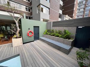 a wooden deck with a red wreath on a building at Belaire Suites Hotel in Durban