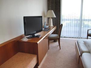 a hotel room with a desk with a television on it at Käfernberg - Weinhotel in Alzenau in Unterfranken