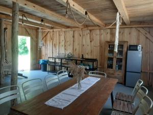 a dining room with a wooden table and chairs at Agroturystyka siedlisko stodoła w stylu boho, imprezy okolicznościowe, 