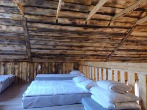 a bedroom with two beds in a wooden ceiling at Agroturystyka siedlisko stodoła w stylu boho, imprezy okolicznościowe, 