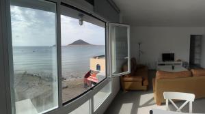 a room with a window with a view of the ocean at Edificio Playa Chica in El M&eacute;dano