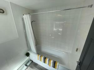 a bathroom with a shower and a white tub at Lovely Seaside House in Cleethorpes Beachfront Area sleeps up-to 6 in Cleethorpes +16 photos