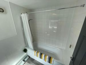 a bathroom with a shower and a white tub at Lovely Seaside House in Cleethorpes - sleeps 6 in Cleethorpes