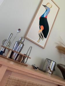 a framed picture of a peacock on a shelf at Forever Endeavour in Mission Beach