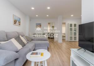 a living room with a couch and a table at La terraza del Falla, Feel Cádiz in Cádiz