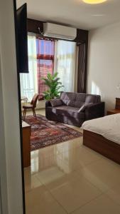 a living room with a bed and a couch at Jerusalem Panorama Hotel in Jerusalem