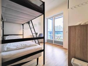 a bedroom with two bunk beds and a balcony at Scandian Apartments - City Park Tallinn in Tallinn