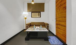 a room with a table and a chair and a door at Treebo Trend Prime Elight in New Delhi